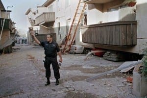 Officer stand guard next to a building after it collapsed after earthquake