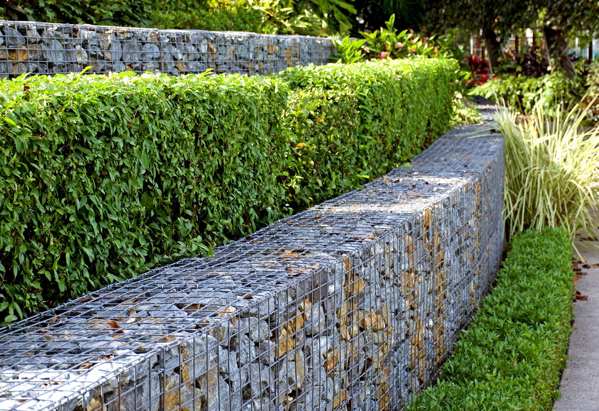 Rock and wire gabions used as retaining walls in a multi tiered garden design