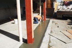 Worker put concrete between two supporting posts in earthquake retrofitting process 21