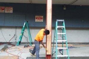 Worker build supporting post in earthquake retrofitting process 22